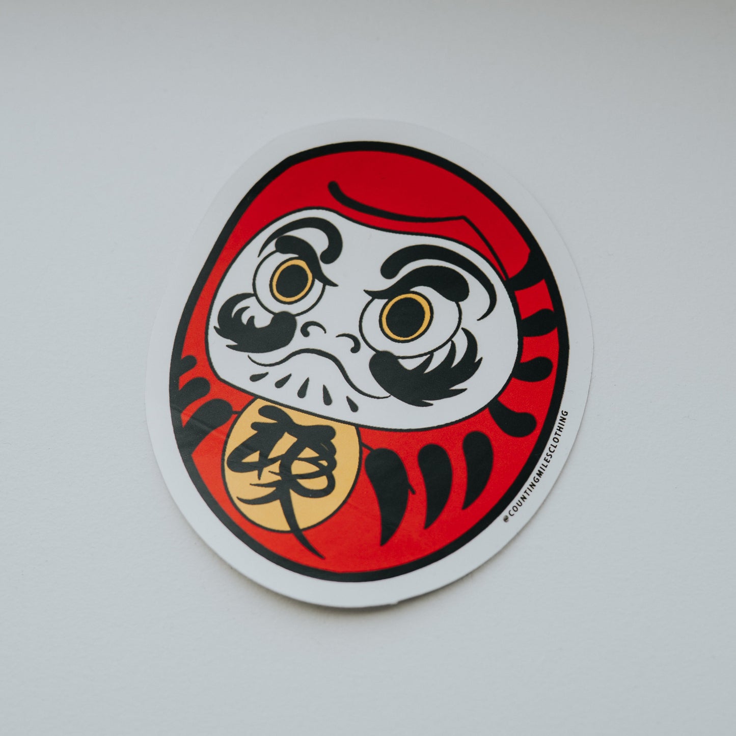 Sticker of a Daruma doll on a white surface